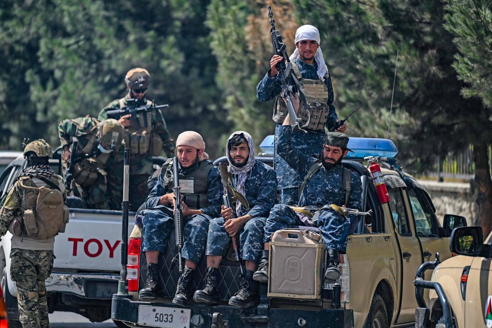 TOPSHOT – Taliban fighters patrol along a street in Kabul on August 29, 2021, as suicide bomb threats hung over the final phase of the US military’s airlift operation from Kabul, with President Joe Biden warning another attack was highly likely before the evacuations end. (Photo by Aamir QURESHI / AFP)